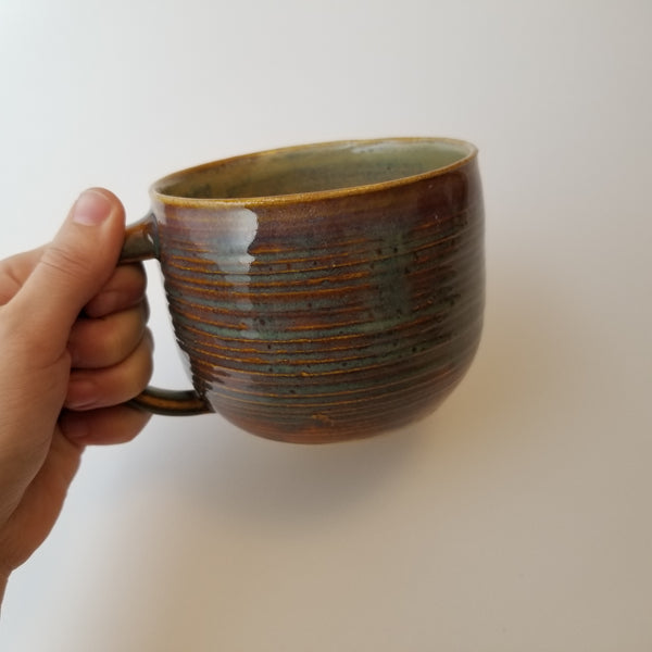 Holding speckle blue mug, little j studio, handmade portland pottery